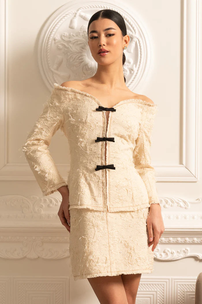 Coordination texturée à épaules dénudées avec des accents d'arc noirs - ivoire